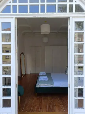 a bedroom with a bed in a room with glass doors at Casa D'Almeida by Porto Stories in Porto