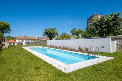 a swimming pool in the backyard of a house at HM - Oporto Studio Pool Oasis in Porto