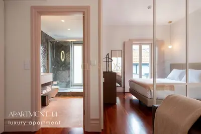 a bedroom with a bed and a room with a mirror at The Clérigos 46 in Porto