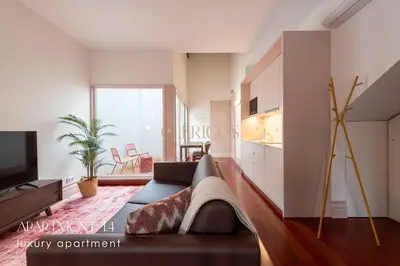 a living room with a couch and a tv at The Clérigos 46 in Porto
