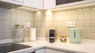 a kitchen with a counter with a coffee maker on it at Serene 1BR Spot by LovelyStay in Porto