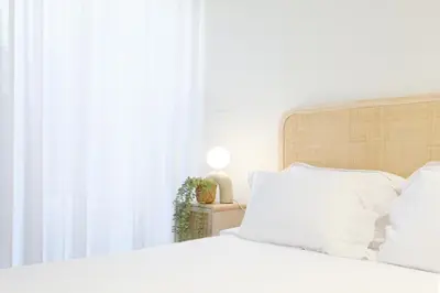 a bedroom with a white bed and a window at Unique Antas Park in Porto