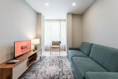 a living room with a couch and a tv at GuestReady - Lovely city retreat in Boavista in Porto