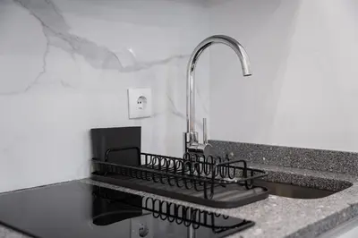 a kitchen counter with a sink and a faucet at GuestReady - Lovely city retreat in Boavista in Porto