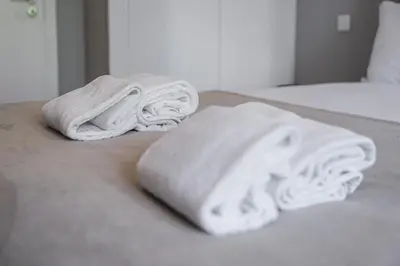 two towels sitting on top of a bed at GuestReady - Lovely city retreat in Boavista in Porto