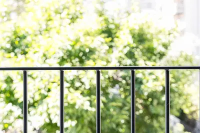 a black fence with trees in the background at GuestReady - Lovely city retreat in Boavista in Porto