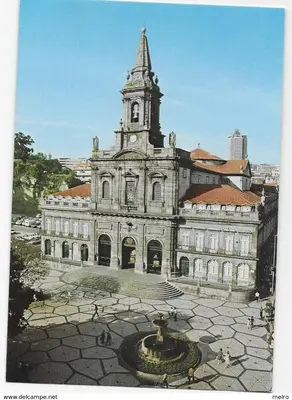 an old building with a clock tower and a fountain at Fantasy Hostel Porto in Porto
