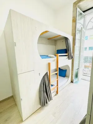 a room with a bunk bed with a window at Fantasy Hostel Porto in Porto