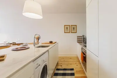 a kitchen with a sink and a dishwasher at Merc Porto Vitoria's Place in Porto