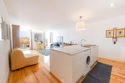 a kitchen with a washing machine in a room at Merc Porto Vitoria's Place in Porto