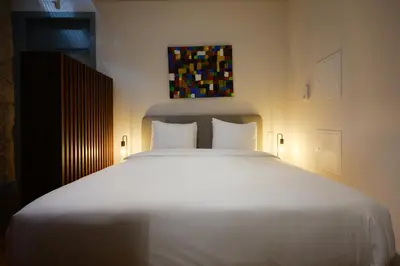 a large white bed with two pillows in a bedroom at Live In Porto - Codeçal in Porto