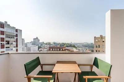 a table and chairs on a balcony with a view at GuestReady - Urban escape with a view in Porto