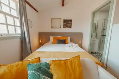 a bedroom with a large bed and a couch at Downtown Suites by Vacationy in Porto