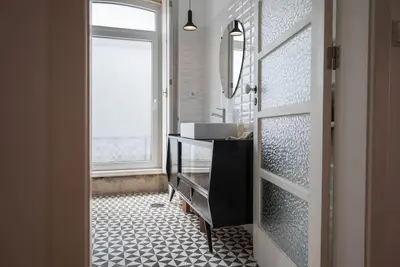 a bathroom with a sink and a mirror at Casa B in Porto