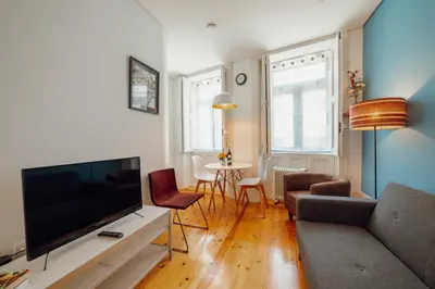 a living room with a large flat screen tv at Downtown Charming by Vacationy in Porto