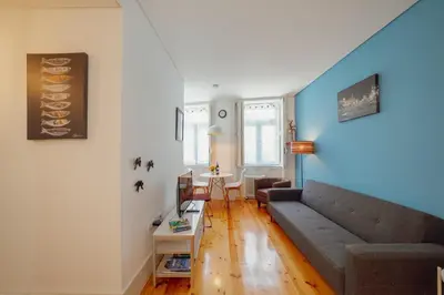 a living room with a couch and a table at Downtown Charming by Vacationy in Porto