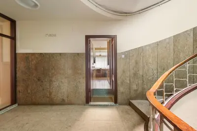 a hallway of a building with a door and stairs at Pelicano in Porto