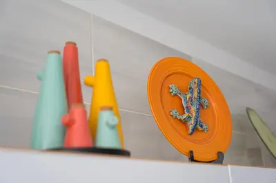 an orange plate sitting on a shelf with other items at Refugio no oPorto in Porto
