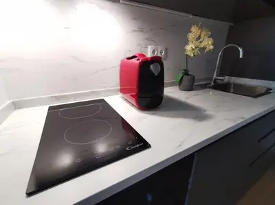 a red toaster sitting on top of a kitchen counter at Modern Downtown Studio in Porto