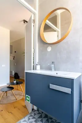 a bathroom with a blue sink and a mirror at Modern Downtown Studio in Porto