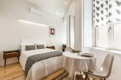 a living room with a table and chairs and a couch at Beco do Paço by Porto Dream Stays in Porto