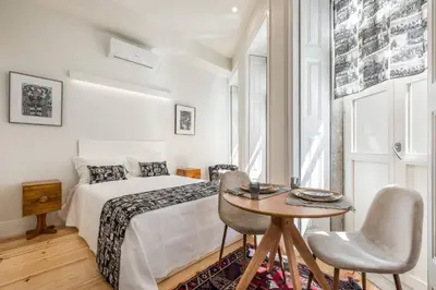 a bedroom with a white bed and a window at Beco do Paço by Porto Dream Stays in Porto