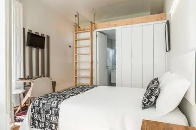 a lamp on a night stand next to a bed at Beco do Paço by Porto Dream Stays in Porto