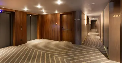 a hallway of a hotel with wooden walls and a hallway at Altis Porto Hotel, a member of Preferred Hotels & Resorts- LVX in Porto