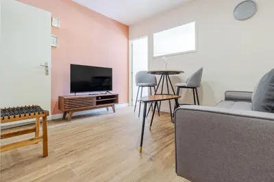 a living room with a couch and a flat screen tv at Porto Riverville Apartments in Porto