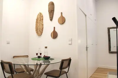a dining room with a glass table and chairs at Modern Flat Near Trindade by LovelyStay in Porto
