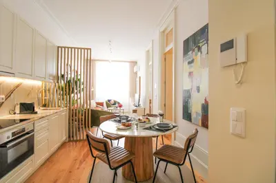 a kitchen with a table and chairs in a room at Luxurious Flat in City Center by LovelyStay in Porto