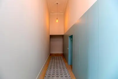 a hallway with a blue door and a tile floor at Luxurious Flat in City Center by LovelyStay in Porto
