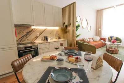 a kitchen with a table with food and wine glasses at Luxurious Flat in City Center by LovelyStay in Porto