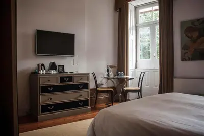 a bedroom with a dresser with a television on the wall at Oporto Loft in Porto