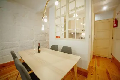 a dining room with a white table and chairs at Vintage Flat by Hosty in Porto
