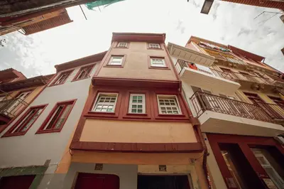 a tall building with red and white windows at Vintage Flat by Hosty in Porto