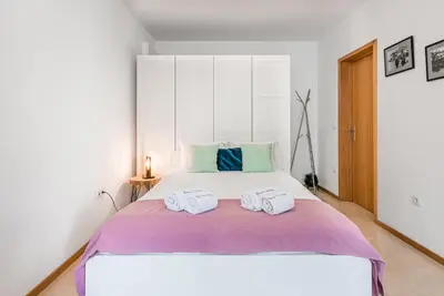a bedroom with a bed with two towels on it at GuestReady - Sunny terrace in downtown Porto in Porto