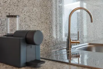 a kitchen counter with a sink and a faucet at GuestReady - Sunny terrace in downtown Porto in Porto