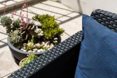a blue tie sitting on a black bench with plants at GuestReady - Sunny terrace in downtown Porto in Porto