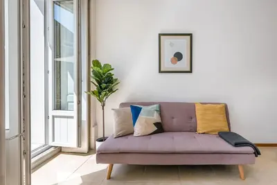 a purple couch in a living room with a window at GuestReady - Sunny terrace in downtown Porto in Porto