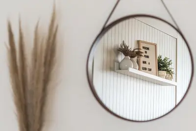 a mirror on a wall with a shelf and plants at GuestReady - Oporto Temptation Apartment in Porto