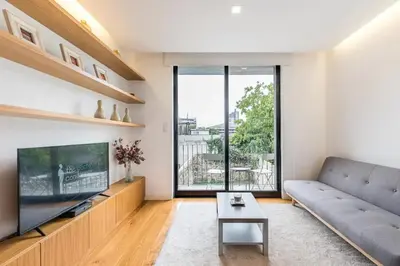 a living room with a couch and a tv at ApartmentsPorto - Leisure Fun Apartment in Porto
