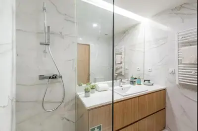 a white bathroom with a shower and a sink at ApartmentsPorto - Leisure Fun Apartment in Porto
