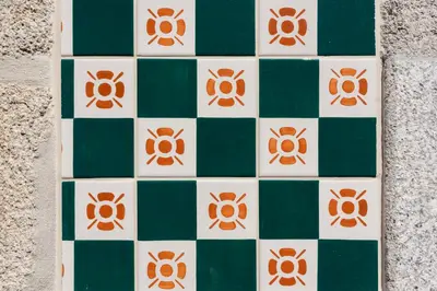 a green and white tiled floor with orange accents at PortoPoint in Porto
