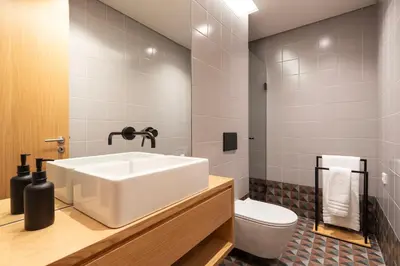 a bathroom with a white sink and a toilet at PortoPoint in Porto