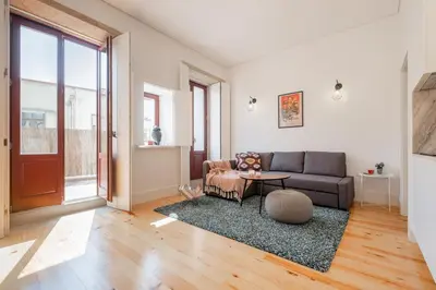 a living room with a couch and a table at Host Wise - Sunny Downtown Apartment in Porto