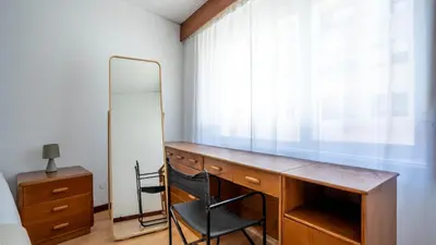 a bedroom with a desk with a chair and a mirror at Cedofeita Vintage w Free Parking by LovelyStay in Porto