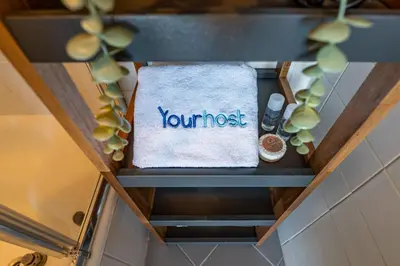 a shelf with a towel with the word yourself on it at Heritage Oporto Downtown in Porto