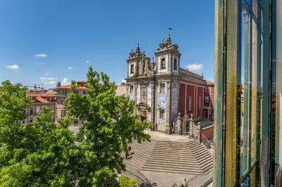 a view of an old building from a window at Heritage Oporto Downtown in Porto