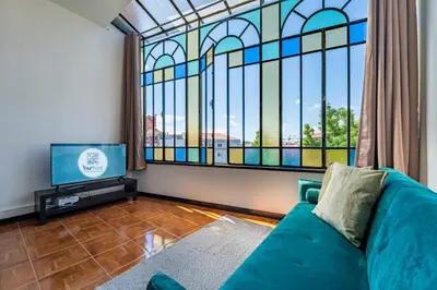 a living room with a couch and a stained glass window at Heritage Oporto Downtown in Porto
